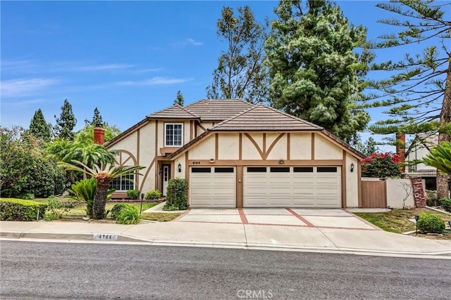 4144 Rainwood Ave, Yorba Linda, CA 92886 - tudor-style house with stucco siding, a garage, and driveway