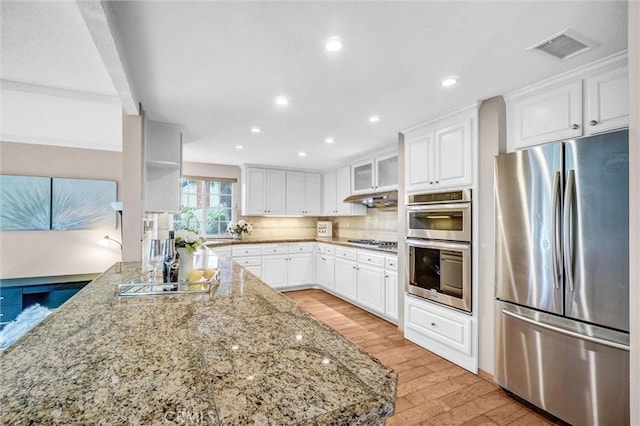 4144 Rainwood Ave, Yorba Linda, CA 92886 - kitchen with appliances with stainless steel finishes, light wood-style flooring, white cabinets, light stone counters, and recessed lighting