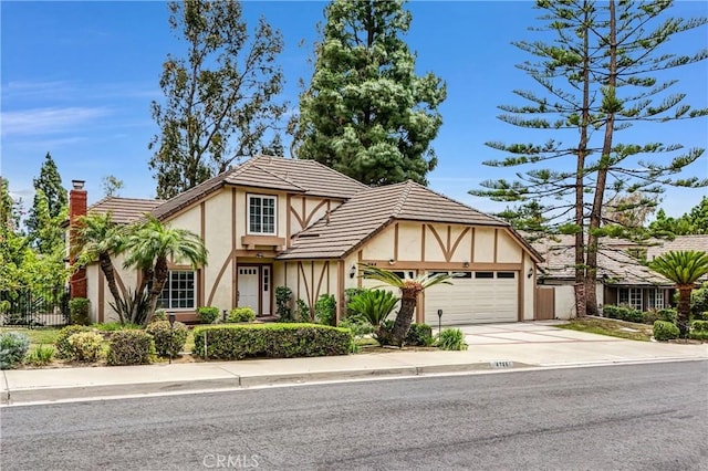 4144 Rainwood Ave, Yorba Linda, CA 92886 - tudor house with a garage, stucco siding, driveway, and a chimney