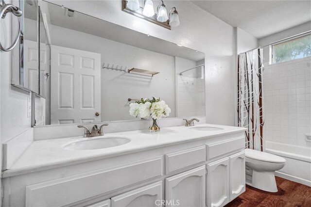 4144 Rainwood Ave, Yorba Linda, CA 92886 - full bathroom featuring double vanity, shower / bathtub combination with curtain, and wood finished floors