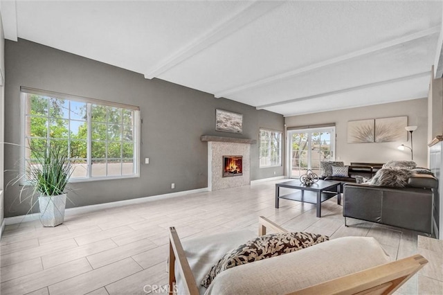 4144 Rainwood Ave, Yorba Linda, CA 92886 - living area featuring beamed ceiling, plenty of natural light, a tile fireplace, and wood finished floors