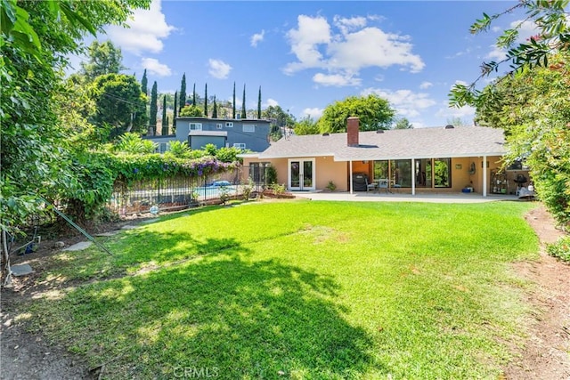 19302 Maynard Way N, Tustin, CA 92705 - back of house with french doors, a patio, a chimney, and stucco siding