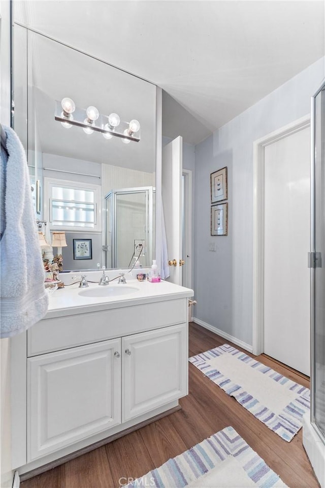 19302 Maynard Way N, Tustin, CA 92705 - bathroom with a shower stall, vanity, and wood finished floors