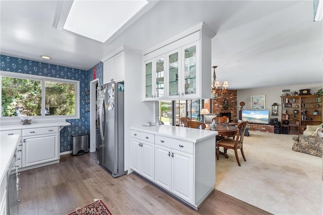 19302 Maynard Way N, Tustin, CA 92705 - kitchen featuring stainless steel fridge with ice dispenser, wallpapered walls, plenty of natural light, and white cabinetry