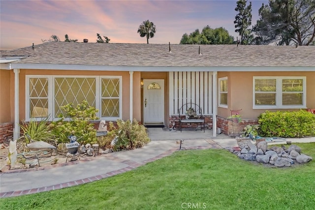 19302 Maynard Way N, Tustin, CA 92705 - view of front facade with board and batten siding, a yard, a porch, and a shingled roof