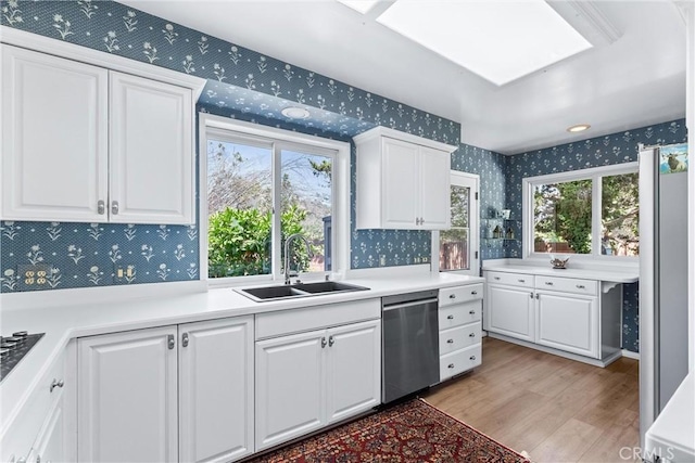 19302 Maynard Way N, Tustin, CA 92705 - kitchen with wallpapered walls, dishwasher, light wood finished floors, healthy amount of natural light, and white cabinets