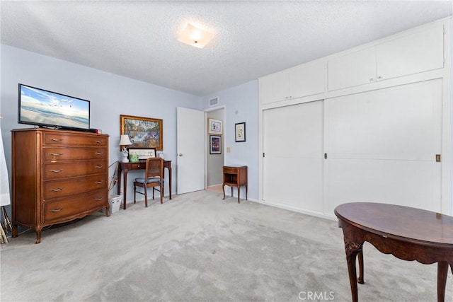 19302 Maynard Way N, Tustin, CA 92705 - living area featuring a textured ceiling, light colored carpet, and a desk