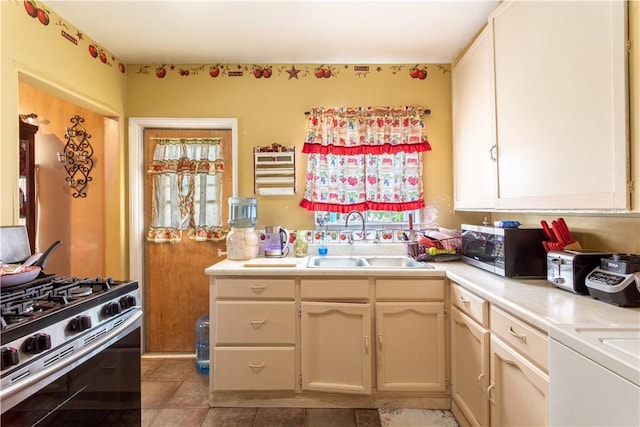 10752 Weigand Ave, Los Angeles, CA 90059 - kitchen with appliances with stainless steel finishes, a sink, light countertops, and light tile patterned floors