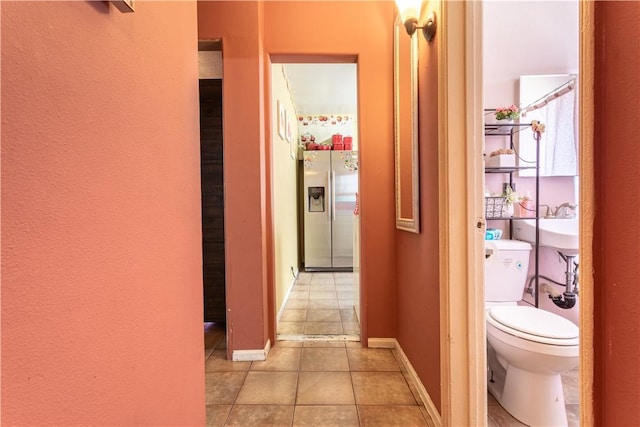 10752 Weigand Ave, Los Angeles, CA 90059 - hall featuring light tile patterned floors and baseboards