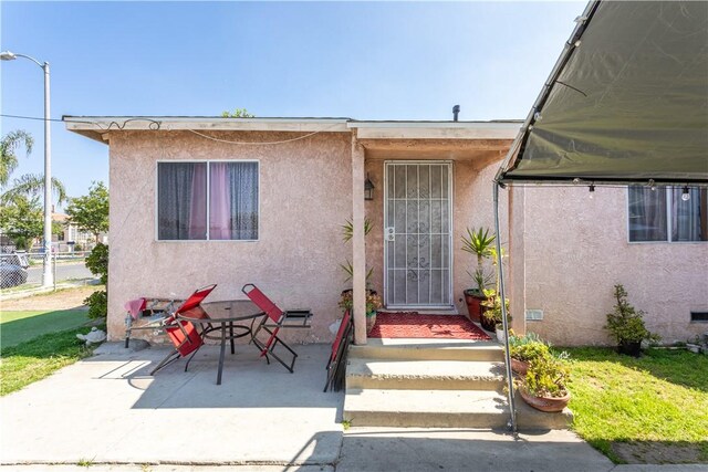 10752 Weigand Ave, Los Angeles, CA 90059 - property entrance with stucco siding and a patio