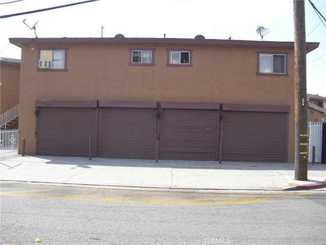 5659 Quinn St, Bell Gardens, CA 90201 - view of front of property with stucco siding, an attached garage, and concrete driveway