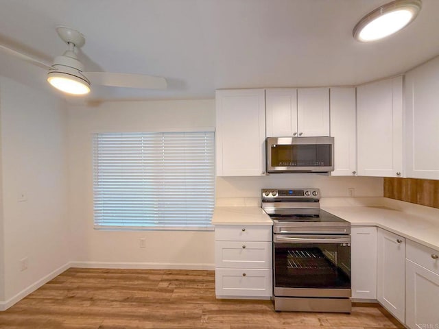 166 N 1st St Unit 18, El Cajon, CA 92021 - kitchen featuring appliances with stainless steel finishes, white cabinets, light wood-style floors, and light countertops