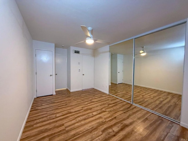 166 N 1st St Unit 18, El Cajon, CA 92021 - unfurnished bedroom with wood finished floors, baseboards, a ceiling fan, and a closet