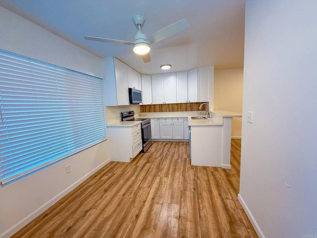 166 N 1st St Unit 18, El Cajon, CA 92021 - kitchen featuring appliances with stainless steel finishes, a sink, light wood finished floors, and baseboards