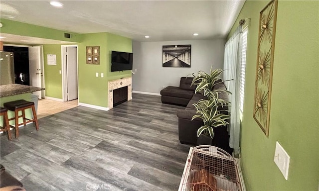 13955 Arthur Ave Unit 4, Paramount, CA 90723 - living area featuring recessed lighting, wood finished floors, baseboards, and a fireplace