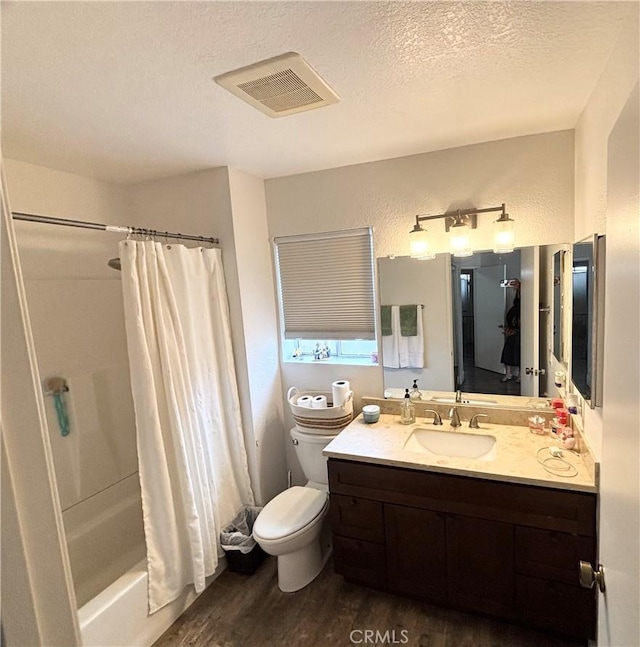 13955 Arthur Ave Unit 4, Paramount, CA 90723 - full bath featuring wood finished floors, vanity, toilet, shower / bathtub combination with curtain, and a textured ceiling