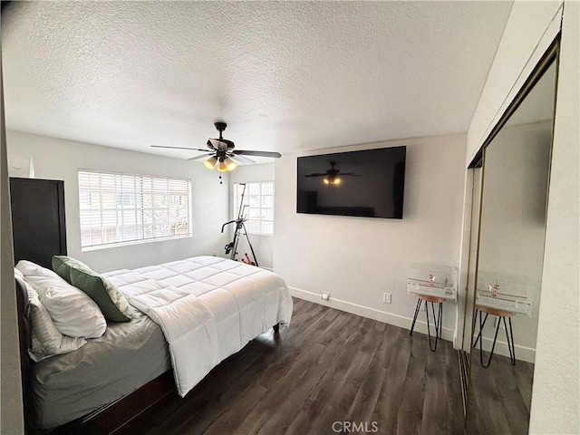 13955 Arthur Ave Unit 4, Paramount, CA 90723 - bedroom with baseboards, dark wood-style flooring, a textured ceiling, and a ceiling fan