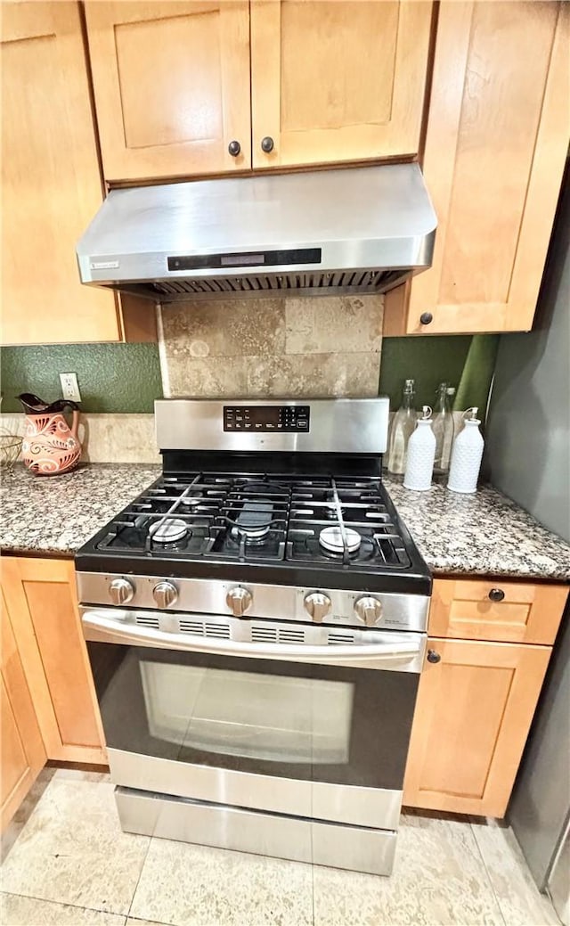 13955 Arthur Ave Unit 4, Paramount, CA 90723 - kitchen featuring stainless steel range with gas cooktop, extractor fan, light brown cabinetry, tasteful backsplash, and light stone countertops