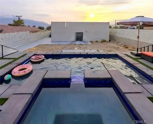 13176 Quinta Way, Desert Hot Springs, CA 92240 - pool at dusk with a fenced backyard