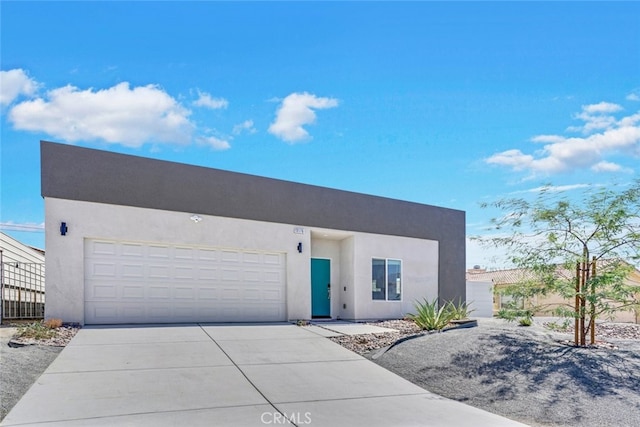 13176 Quinta Way, Desert Hot Springs, CA 92240 - modern home with stucco siding, concrete driveway, and a garage
