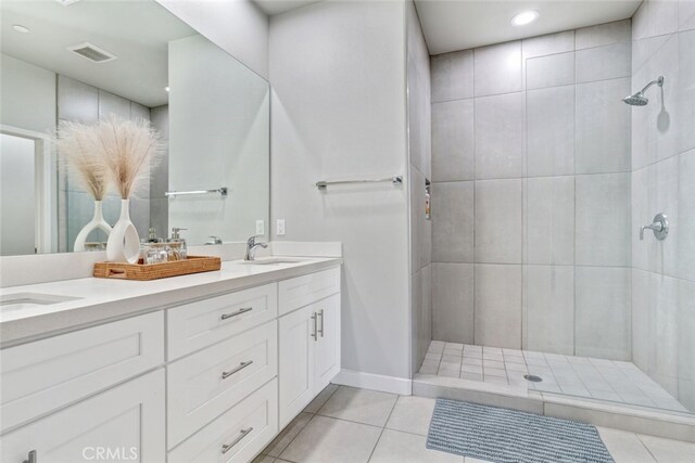 13176 Quinta Way, Desert Hot Springs, CA 92240 - full bathroom with tile patterned flooring, double vanity, tiled shower, recessed lighting, and baseboards
