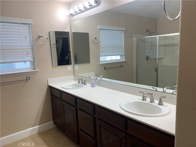 538 Burnt Ranch Way, Chico, CA 95973 - full bath with a shower stall, tile patterned floors, double vanity, plenty of natural light, and a textured wall