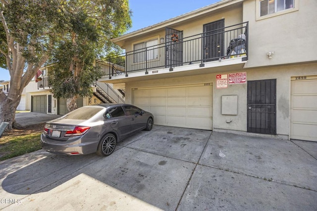2692 Anchor Ave, Port Hueneme, CA 93041 - view of front of house featuring stucco siding, concrete driveway, an attached garage, and stairway