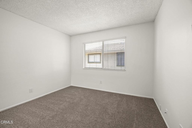 2692 Anchor Ave, Port Hueneme, CA 93041 - unfurnished room with dark carpet and a textured ceiling