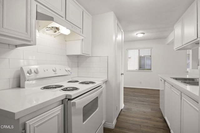 2692 Anchor Ave, Port Hueneme, CA 93041 - kitchen featuring white range with electric stovetop, under cabinet range hood, light countertops, tasteful backsplash, and dark wood-style flooring