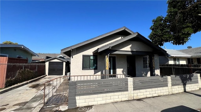 1082 Lewis Ave, Long Beach, CA 90813 - bungalow-style house with stucco siding, a fenced front yard, concrete driveway, and a gate