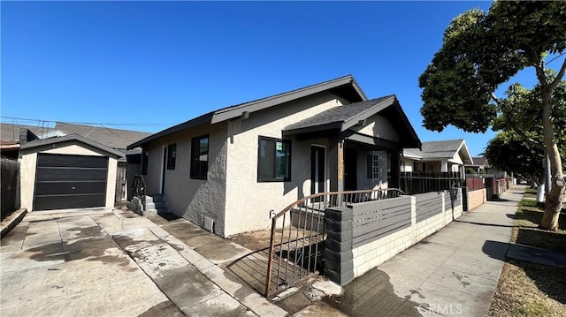 1082 Lewis Ave, Long Beach, CA 90813 - view of front of house featuring stucco siding, an outbuilding, concrete driveway, and a garage