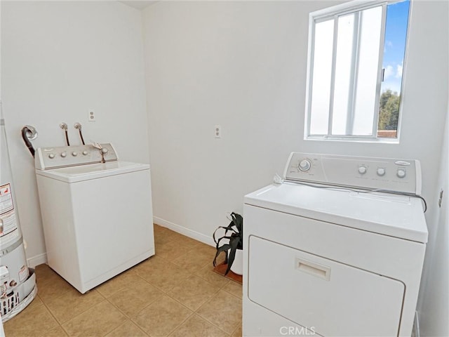 5924 S Pacific Coast Hwy Unit 22, Redondo Beach, CA 90277 - laundry area featuring independent washer and dryer, plenty of natural light, light tile patterned floors, and baseboards