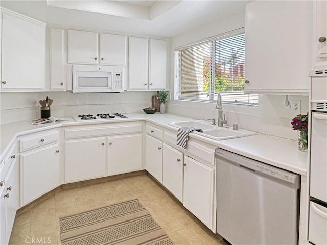 5924 S Pacific Coast Hwy Unit 22, Redondo Beach, CA 90277 - kitchen with white appliances, a sink, light tile patterned floors, white cabinetry, and light countertops