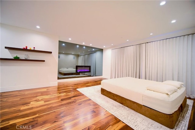 3964 Sumac Dr, Sherman Oaks, CA 91403 - bedroom featuring wood finished floors, baseboards, recessed lighting, and a glass covered fireplace