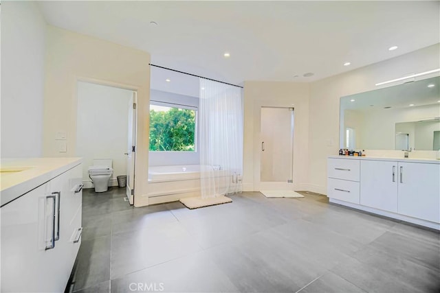 3964 Sumac Dr, Sherman Oaks, CA 91403 - full bath with two vanities, a garden tub, a stall shower, toilet, and recessed lighting