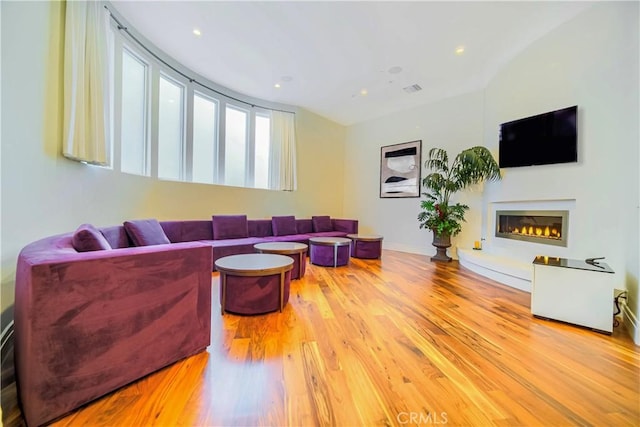 3964 Sumac Dr, Sherman Oaks, CA 91403 - living area with wood finished floors, a glass covered fireplace, and recessed lighting