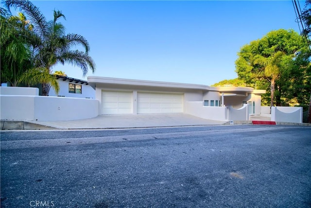 3964 Sumac Dr, Sherman Oaks, CA 91403 - view of front of home with a garage, concrete driveway, and stucco siding