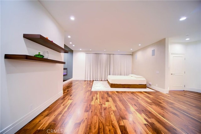 3964 Sumac Dr, Sherman Oaks, CA 91403 - bedroom with wood finished floors, recessed lighting, baseboards, and a glass covered fireplace