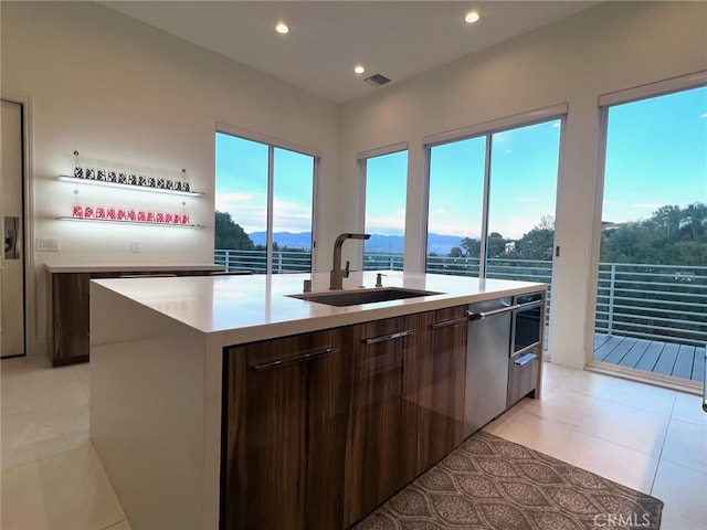 3964 Sumac Dr, Sherman Oaks, CA 91403 - kitchen featuring a sink, modern cabinets, an island with sink, light countertops, and light tile patterned floors