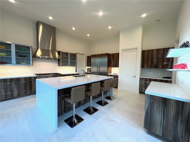 3964 Sumac Dr, Sherman Oaks, CA 91403 - kitchen with wall chimney range hood, modern cabinets, a kitchen breakfast bar, a large island, and recessed lighting