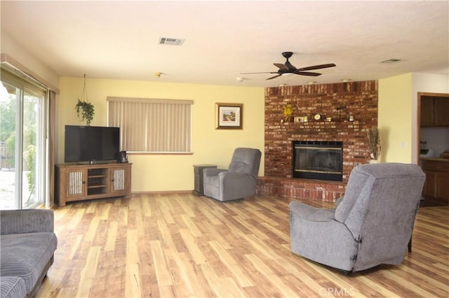 19180 Osceola Rd, Apple Valley, CA 92307 - living area with ceiling fan, wood finished floors, a fireplace, and baseboards