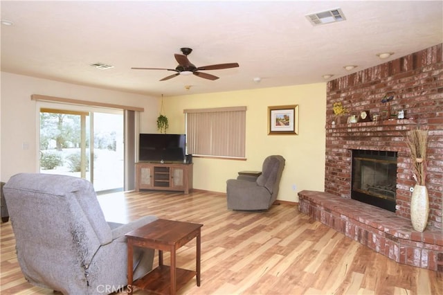 19180 Osceola Rd, Apple Valley, CA 92307 - living area with wood finished floors, ceiling fan, a fireplace, and baseboards