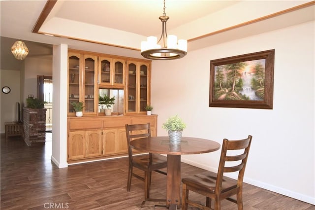 19180 Osceola Rd, Apple Valley, CA 92307 - dining area featuring a chandelier, dark wood finished floors, baseboards, and a raised ceiling