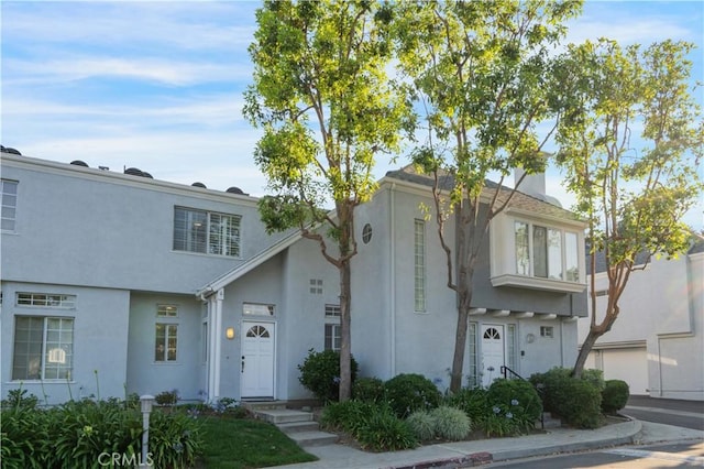 28215 Paseo El Siena Unit 46, Laguna Niguel, CA 92677 - view of front of home with stucco siding and a chimney