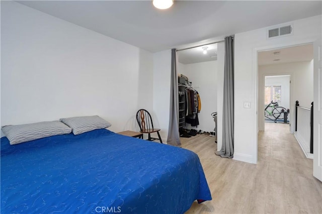 28215 Paseo El Siena Unit 46, Laguna Niguel, CA 92677 - bedroom with light wood-type flooring and a walk in closet