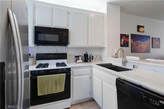 28215 Paseo El Siena Unit 46, Laguna Niguel, CA 92677 - kitchen with black appliances, white cabinetry, and light stone counters