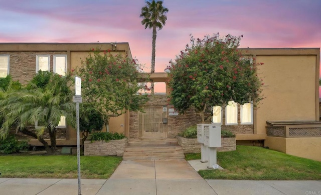 5511 Adelaide Ave Unit 20, San Diego, CA 92115 - view of front of home featuring stucco siding, stone siding, and a lawn