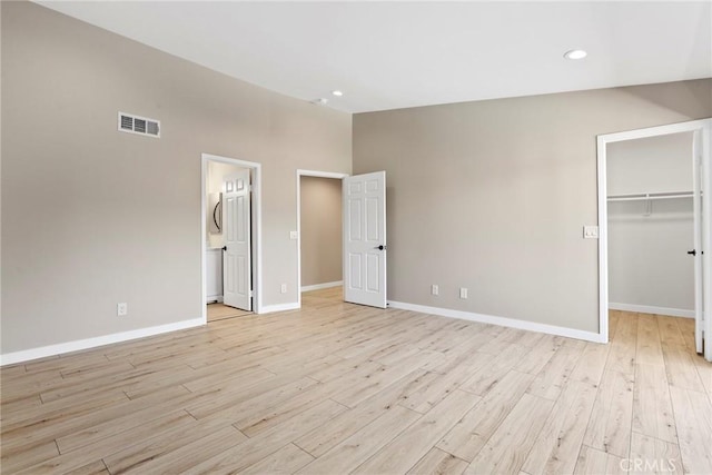 26322 W Bravo Ln, Calabasas, CA 91302 - unfurnished bedroom with light wood-style floors, baseboards, a walk in closet, recessed lighting, and connected bathroom