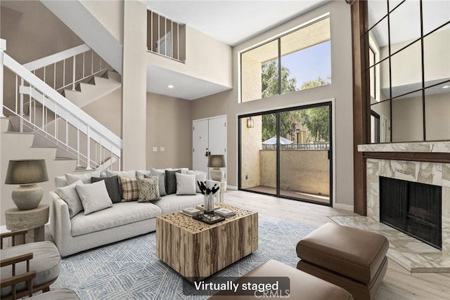 26322 W Bravo Ln, Calabasas, CA 91302 - living area with a high ceiling, wood finished floors, stairs, and a high end fireplace