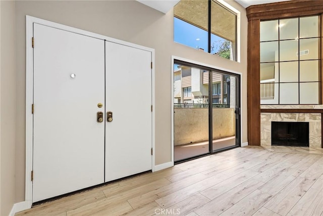 26322 W Bravo Ln, Calabasas, CA 91302 - foyer entrance featuring wood finished floors, a high end fireplace, baseboards, and a high ceiling